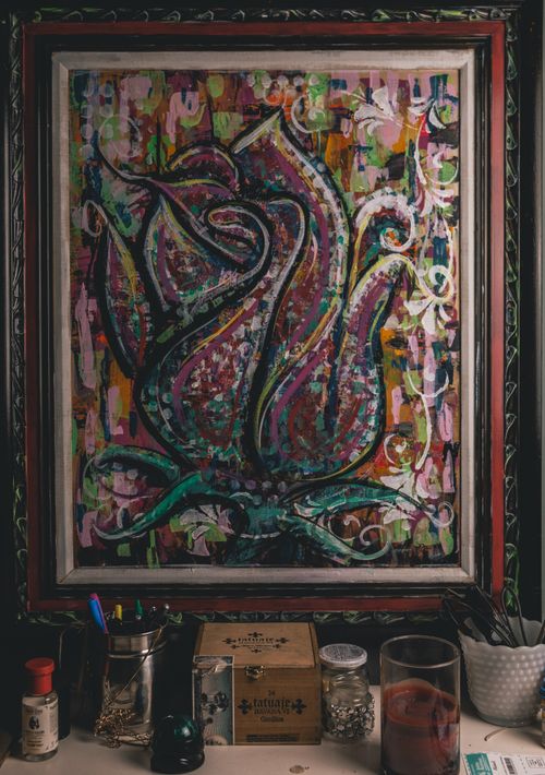 Free A vibrant multi-colored abstract floral painting in a decorative frame. Stock Photo