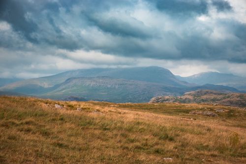 Free Scenic mountains under a dramatic overcast sky, perfect for natural beauty enthusiasts. Stock Photo