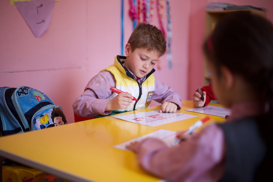 Young Preschool Kids Drawing with Magic Markers 