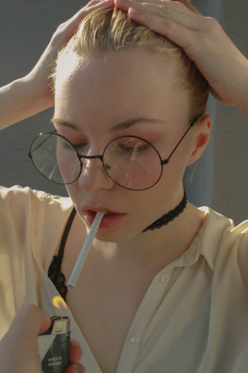 Woman in Eyeglasses Smoking Cigarette