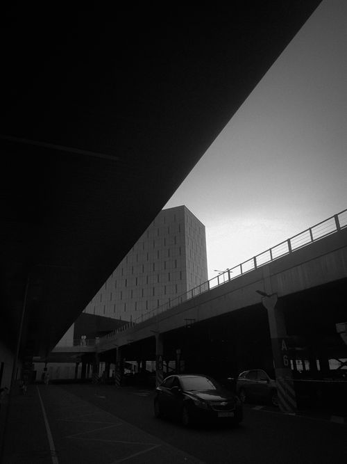 Free Striking black and white urban scene featuring modern architecture and transportation dynamics. Stock Photo