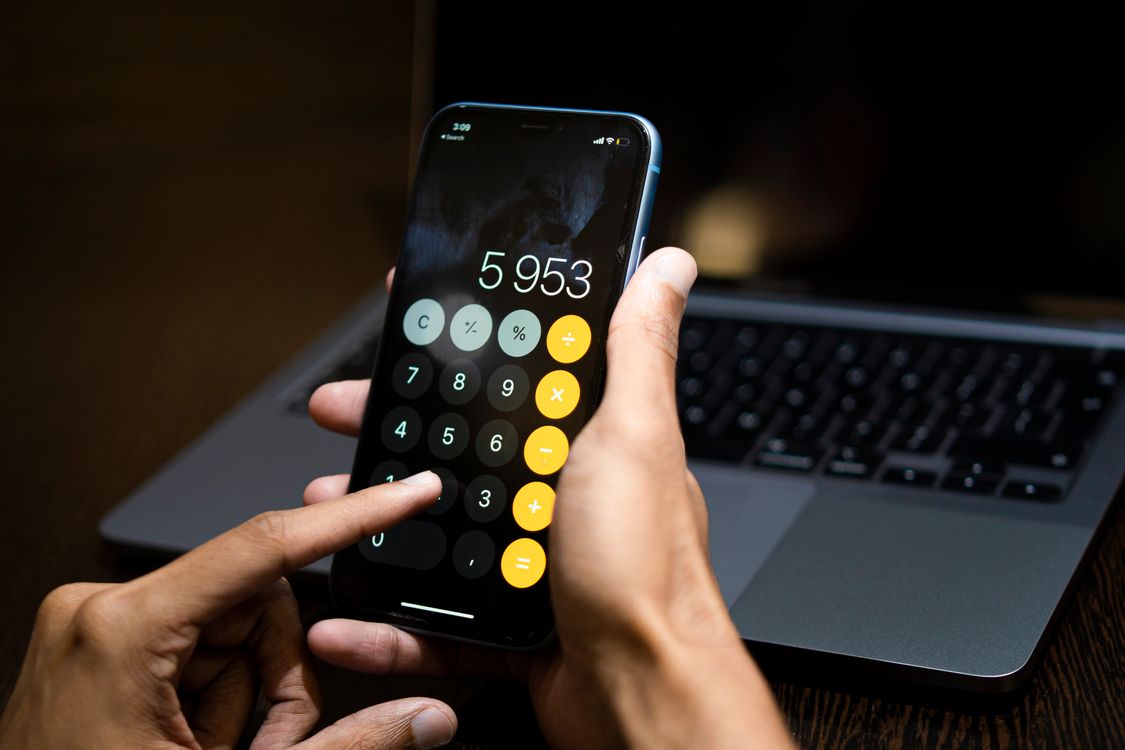 Calculator User Hands of Person Using Calculator on Smartphone · Free Stock Photo