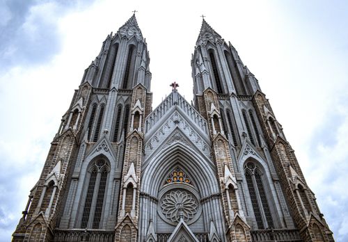Free Gothic-style facade of St. Philomena's Cathedral in Mysuru, India, with towering spires. Stock Photo