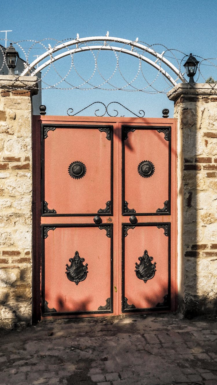 An Antique Gate Between Stone Walls 