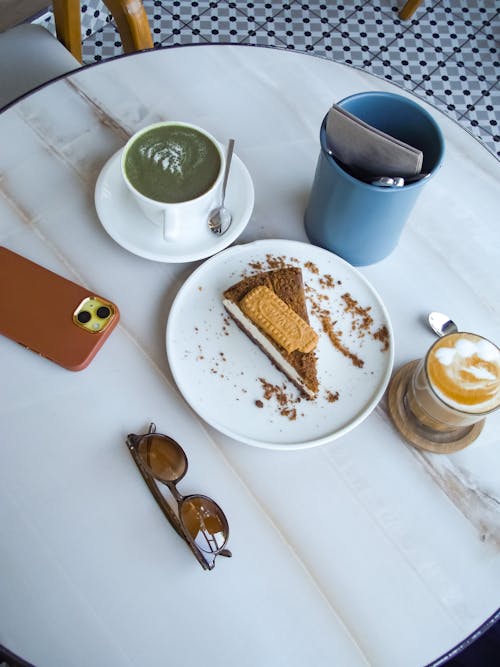 Coffee, Matcha and a Slice of Cake on the Table 