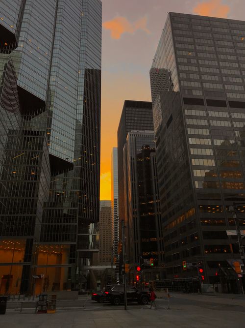 Free Stunning Toronto cityscape featuring skyscrapers at dusk with a vibrant sunset. Stock Photo