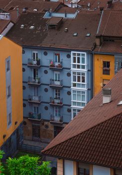 A top-down view of urban residential buildings in Bilbao, showcasing diverse architecture.