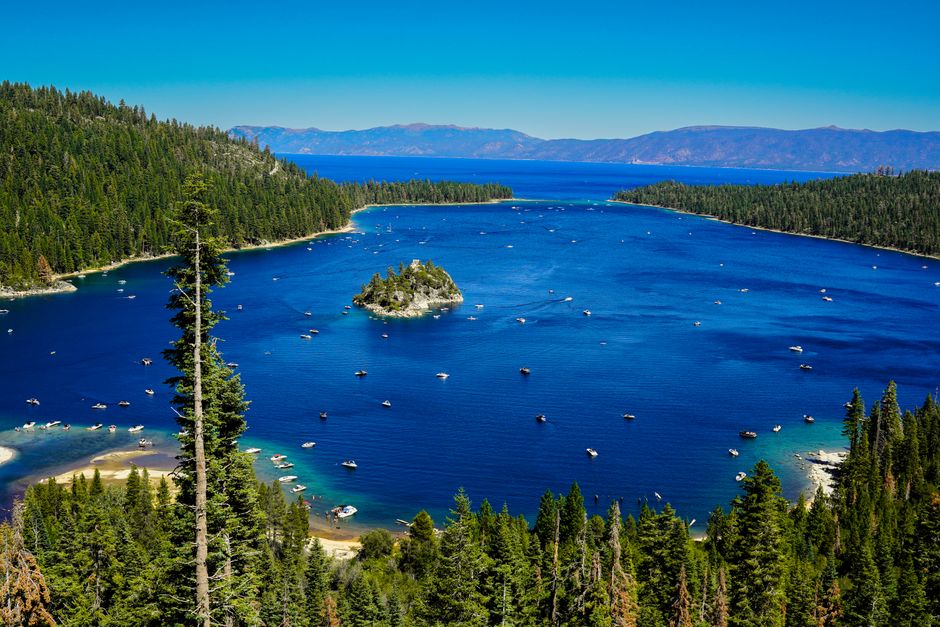 Stunning aerial view of Emerald Bay with Fannette Island and boats dotting the vibrant blue water.
