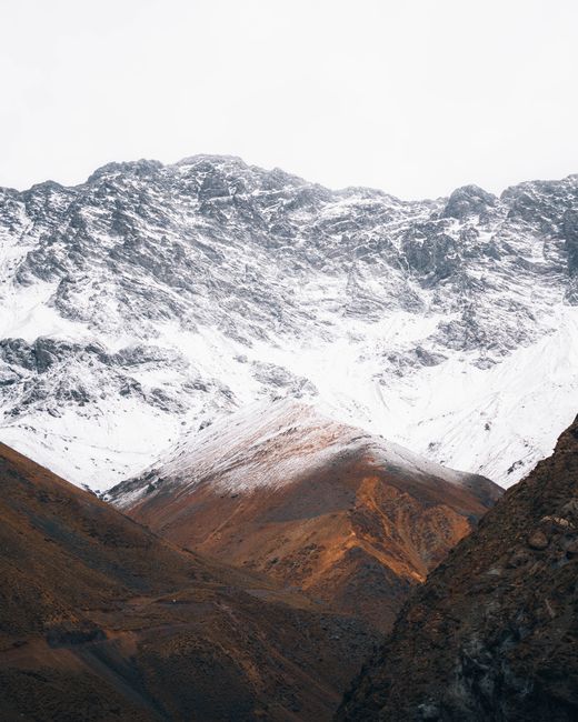 Majestic snow-covered mountains with rugged landscapes, showcasing nature's raw beauty.