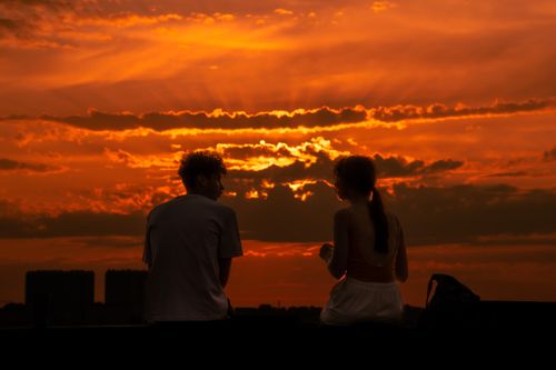 Free Silhouette of a couple sitting together at sunset in Brussels, Belgium. Stock Photo