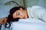 Close-Up Photo of Woman Lying on Bed