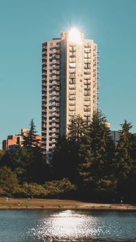 Sunlit skyscraper with waterfront view in North Vancouver, BC.