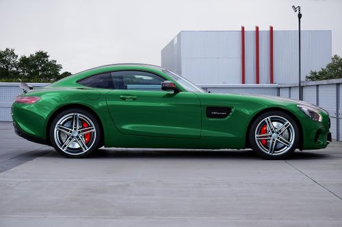 Free Sleek green Mercedes-Benz AMG sports car parked in urban setting, showcasing luxury and performance. Stock Photo