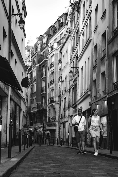 Woman and Man Walking on Street in Black and White