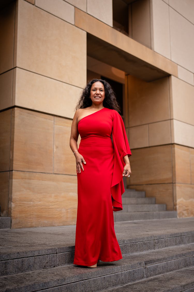 Woman In Red Evening Standing On Steps