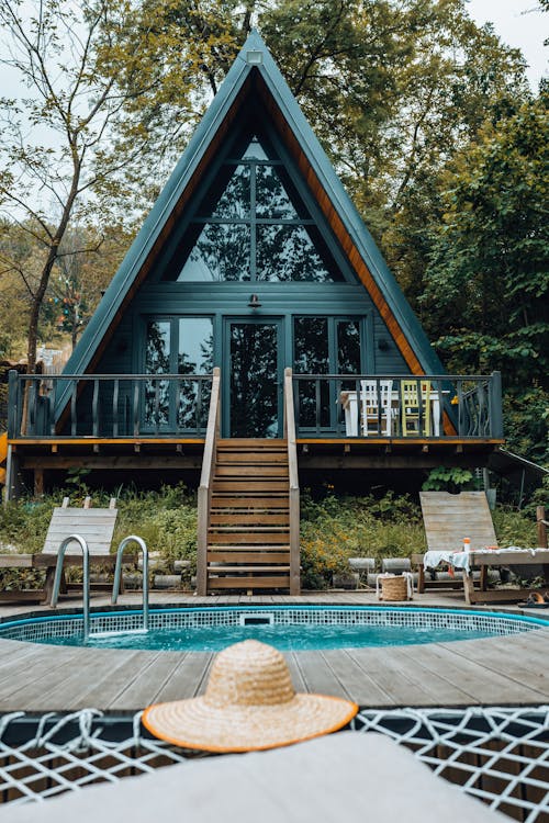 Hat near Pool at House in Forest