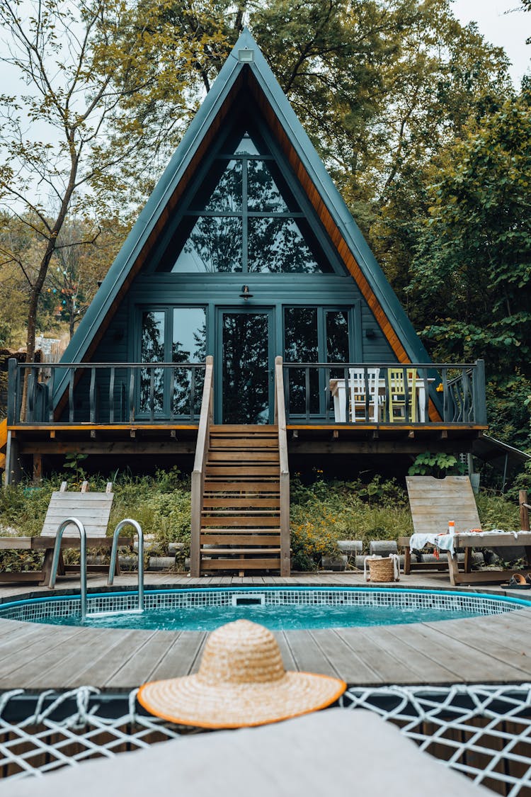 Hat Near Pool At House In Forest