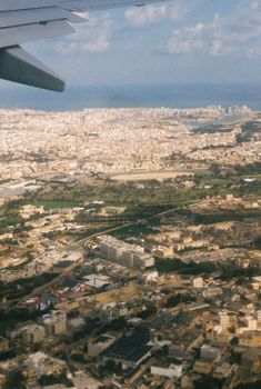Scenic aerial view of Malta showcasing urban cityscape and Mediterranean sea.