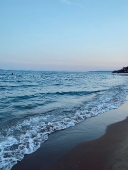 Beautiful twilight view of İstanbul's beach with gentle waves and a calm sea horizon.