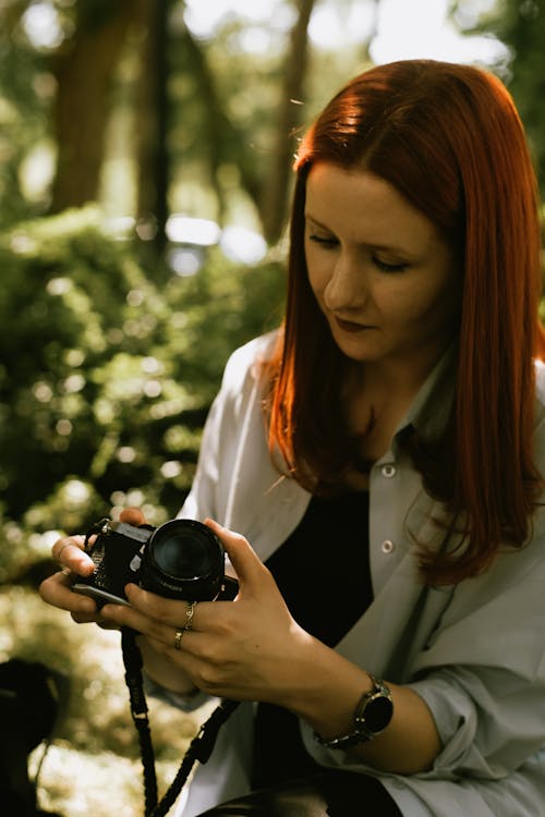 Woman with Camera in the Forest