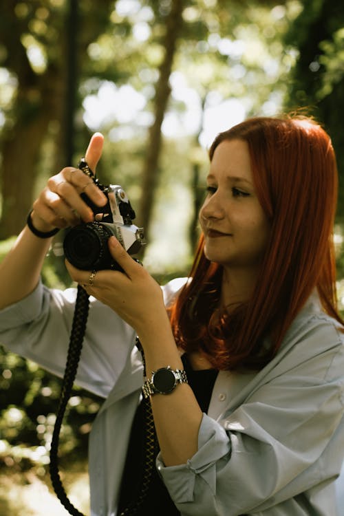 Woman Taking Photos in the Forest