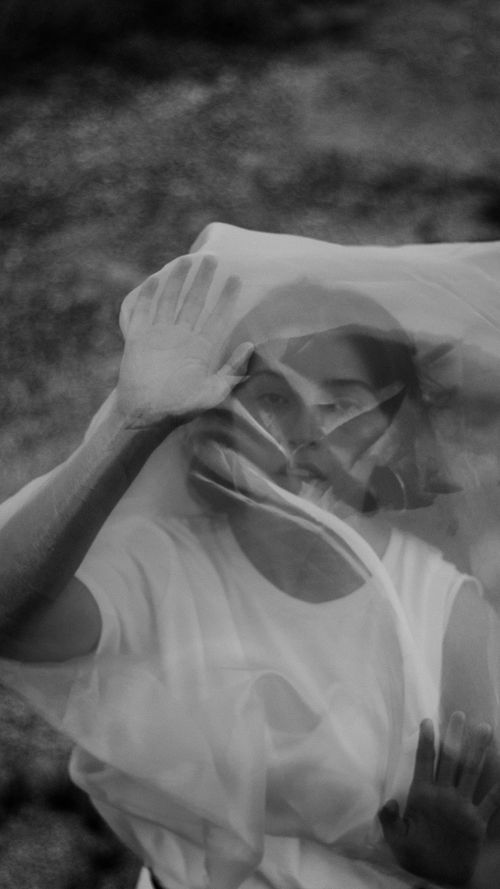 Free Artistic black and white portrait of woman with veil, expressive hands. Stock Photo