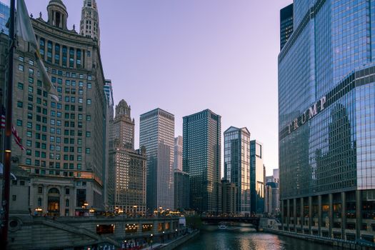 Trump's Tariffs: Analyzing Their Impact on the U.S. Economy 1 Chicago's skyline at dusk featuring modern skyscrapers and historic architecture along the river.