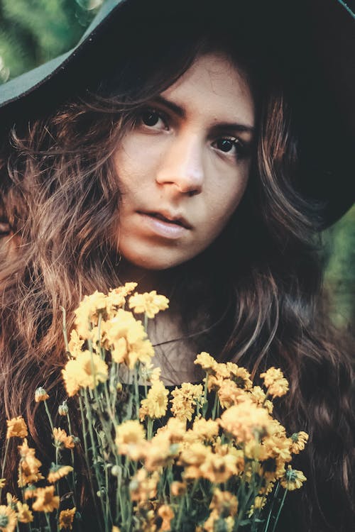 Portrait of a Young Woman with a Bouquet of Yellow Flowers 