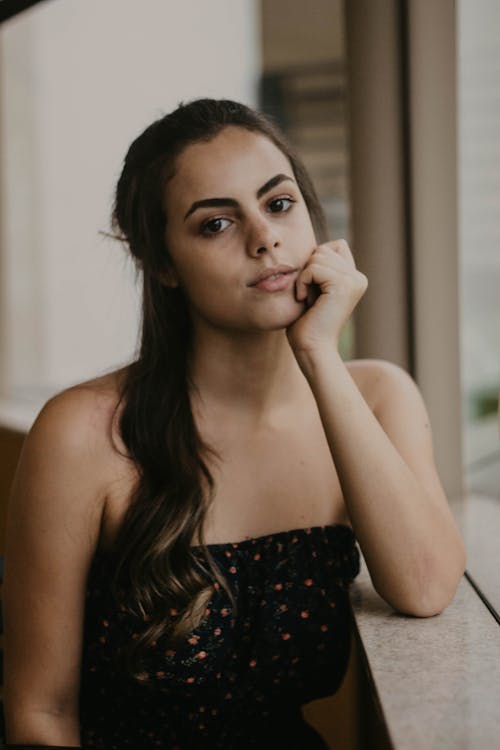 Portrait of a Young Woman Leaning on a Window Sill 