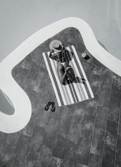 Woman Sunbathing by the Pool 