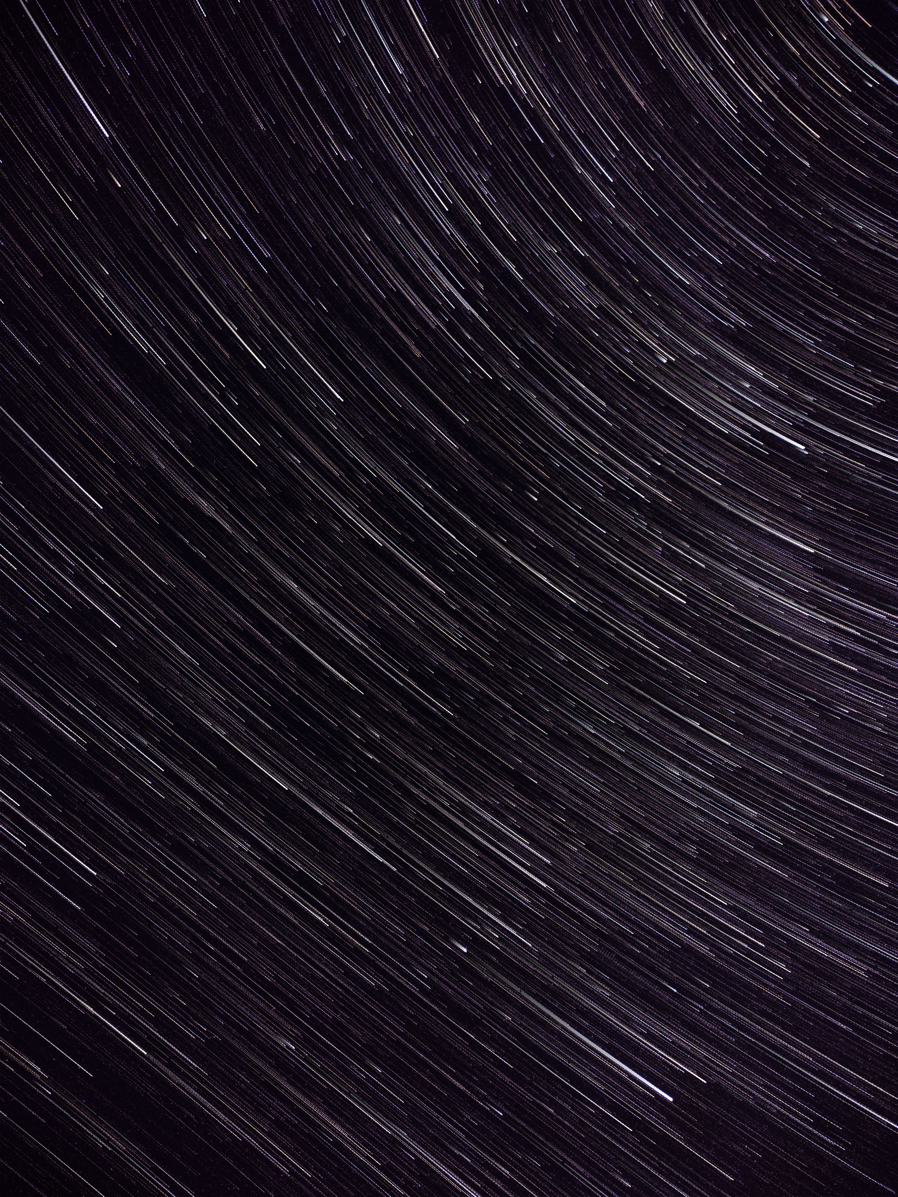 Captivating long exposure photo showing swirling star trails in the night sky.