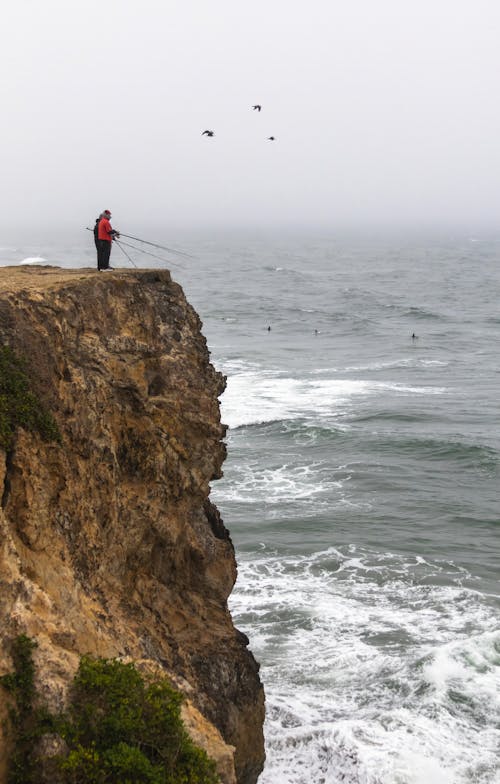 Anglers Fishing from High Cliff