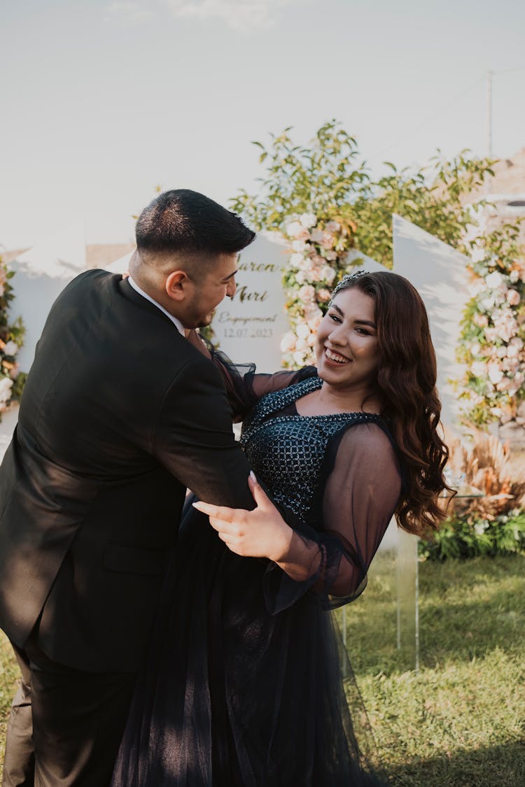 Smiling Couple Dancing In Yard