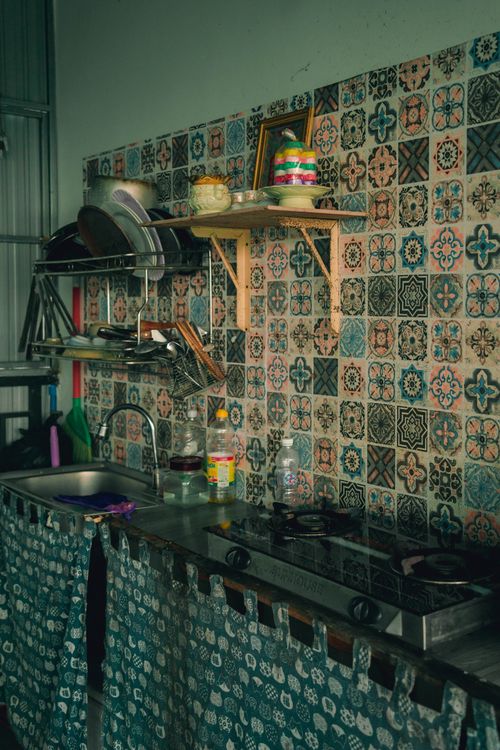 Free Cozy kitchen interior with a patterned tile backsplash and cooking essentials. Stock Photo
