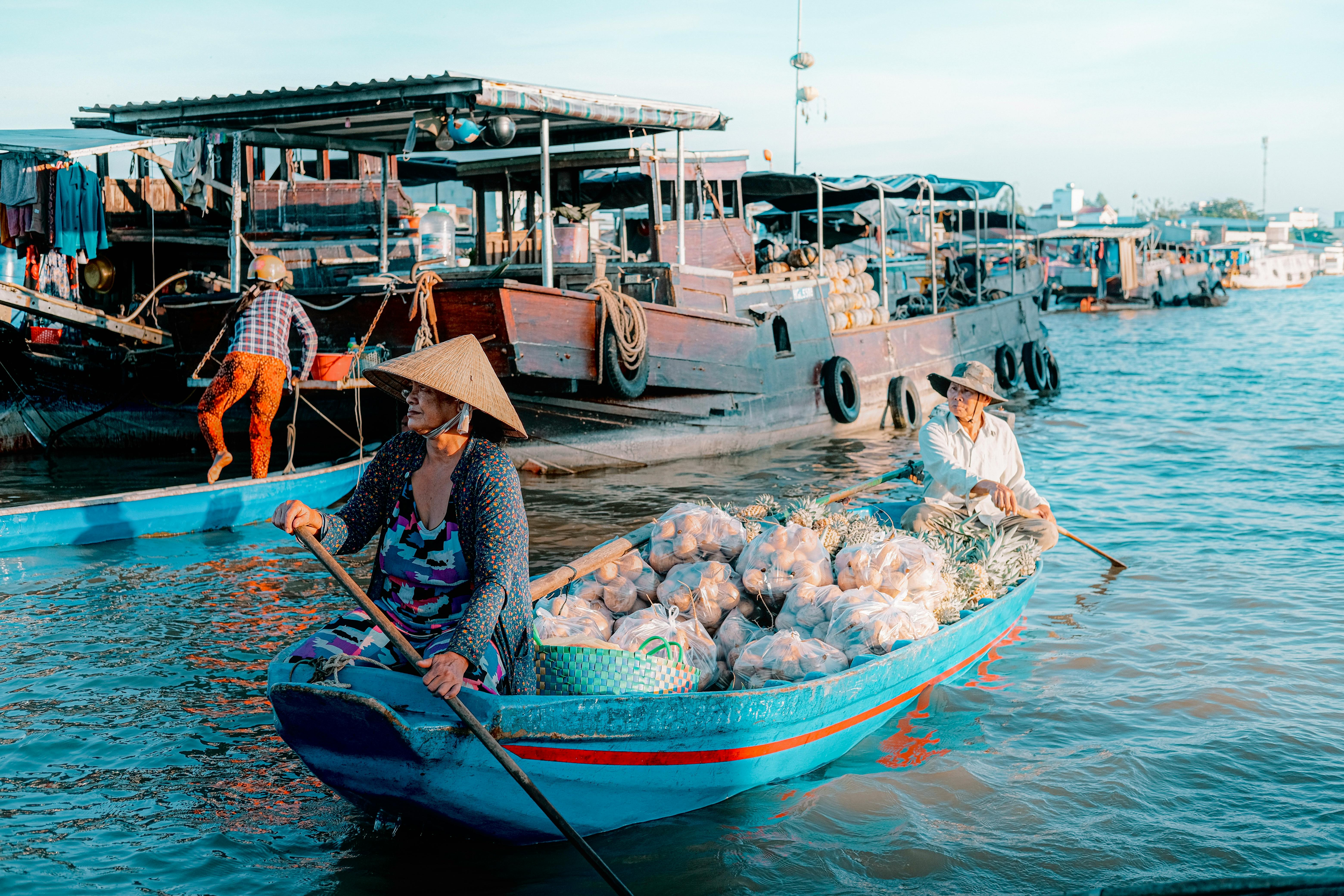 Men Swimming on a Traditional Boat · Free Stock Photo