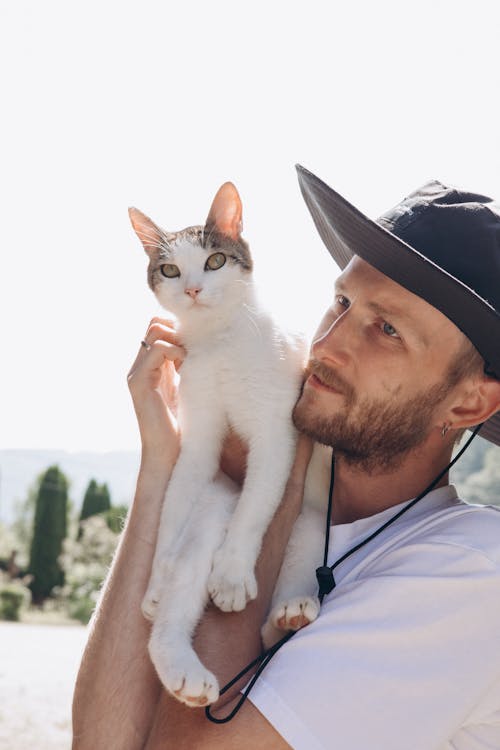 Man Holding o Cat in Sunlight