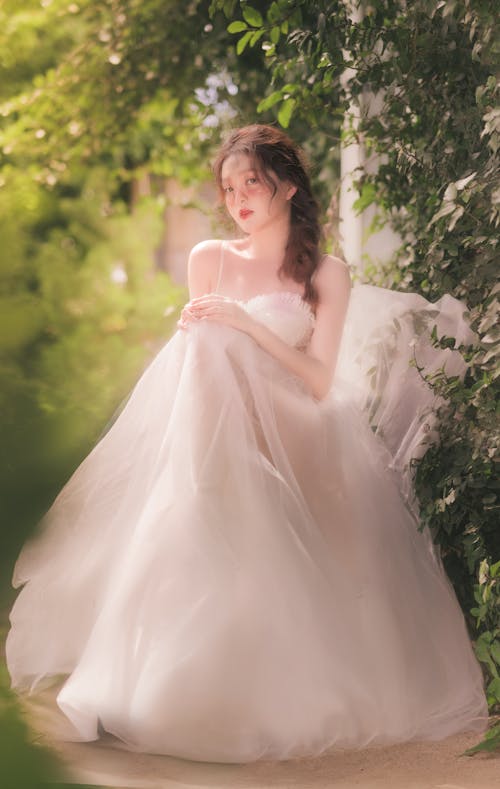 Woman Sitting in Wedding Dress