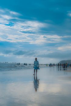 A peaceful scene of people enjoying the beach at Chattogram, Bangladesh.