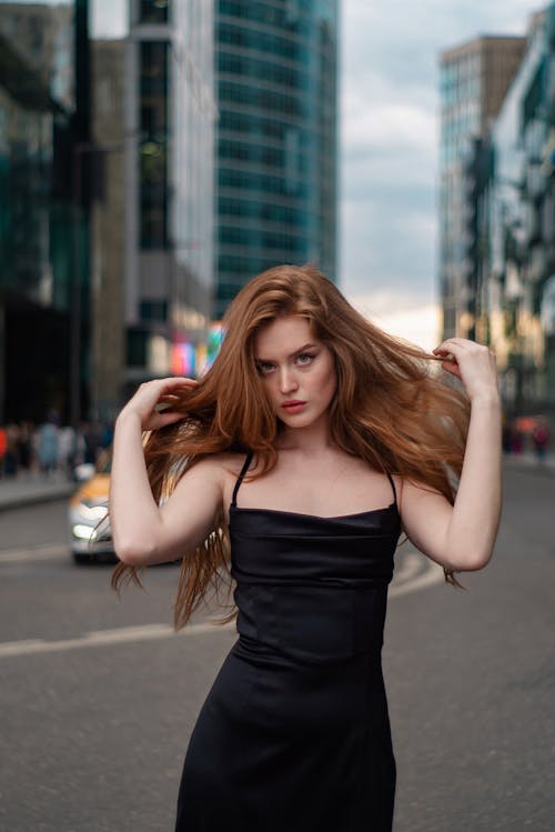 Woman Posing on Street in Black Straps Dress