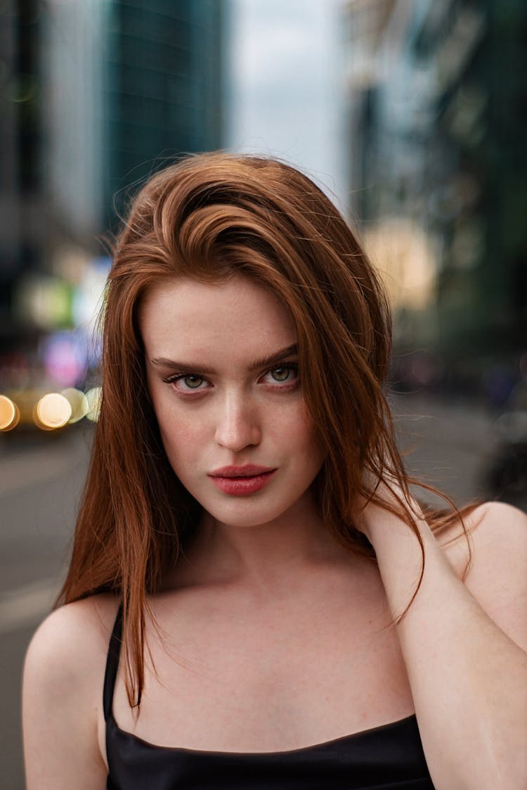 Woman Fixing Hair On Street