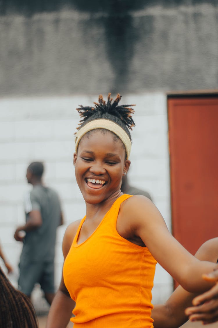 Teenager Girl In Yellow Tank Top Dancing On The Street