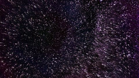 An abstract depiction of a starry night sky with dark violet hues and texture, ideal for backgrounds.