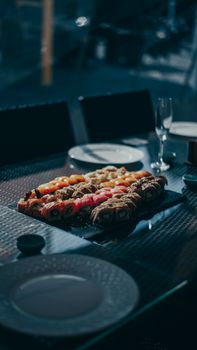 A beautifully arranged sushi platter under soft lighting, perfect for a fine dining experience.
