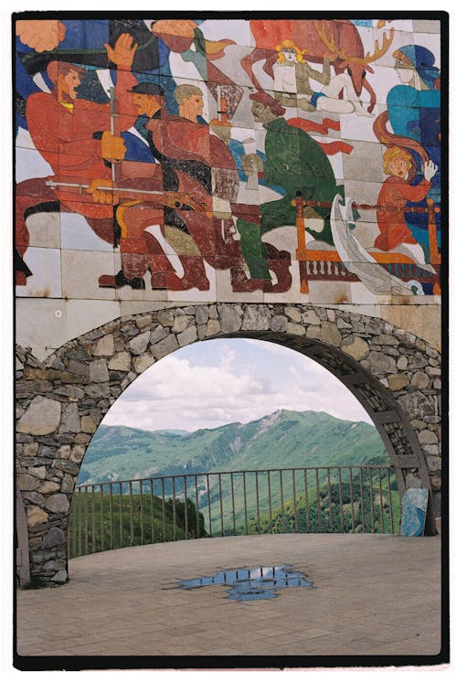 Mosaic on Stone Arch in Mountains Landscape