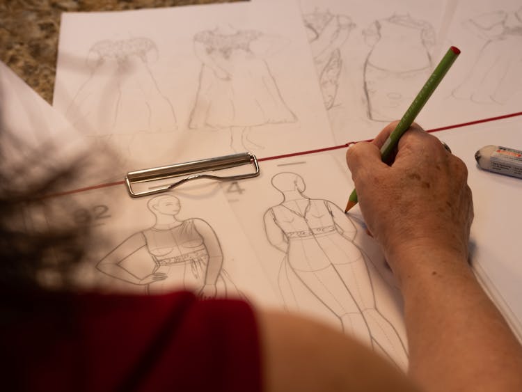 Woman Drawing A Dress Design