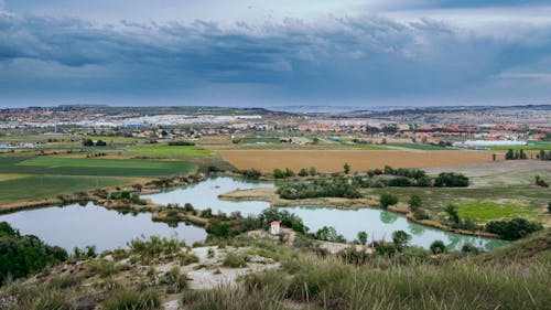 Lakes among Agricultural Fields under Cloudy Sky