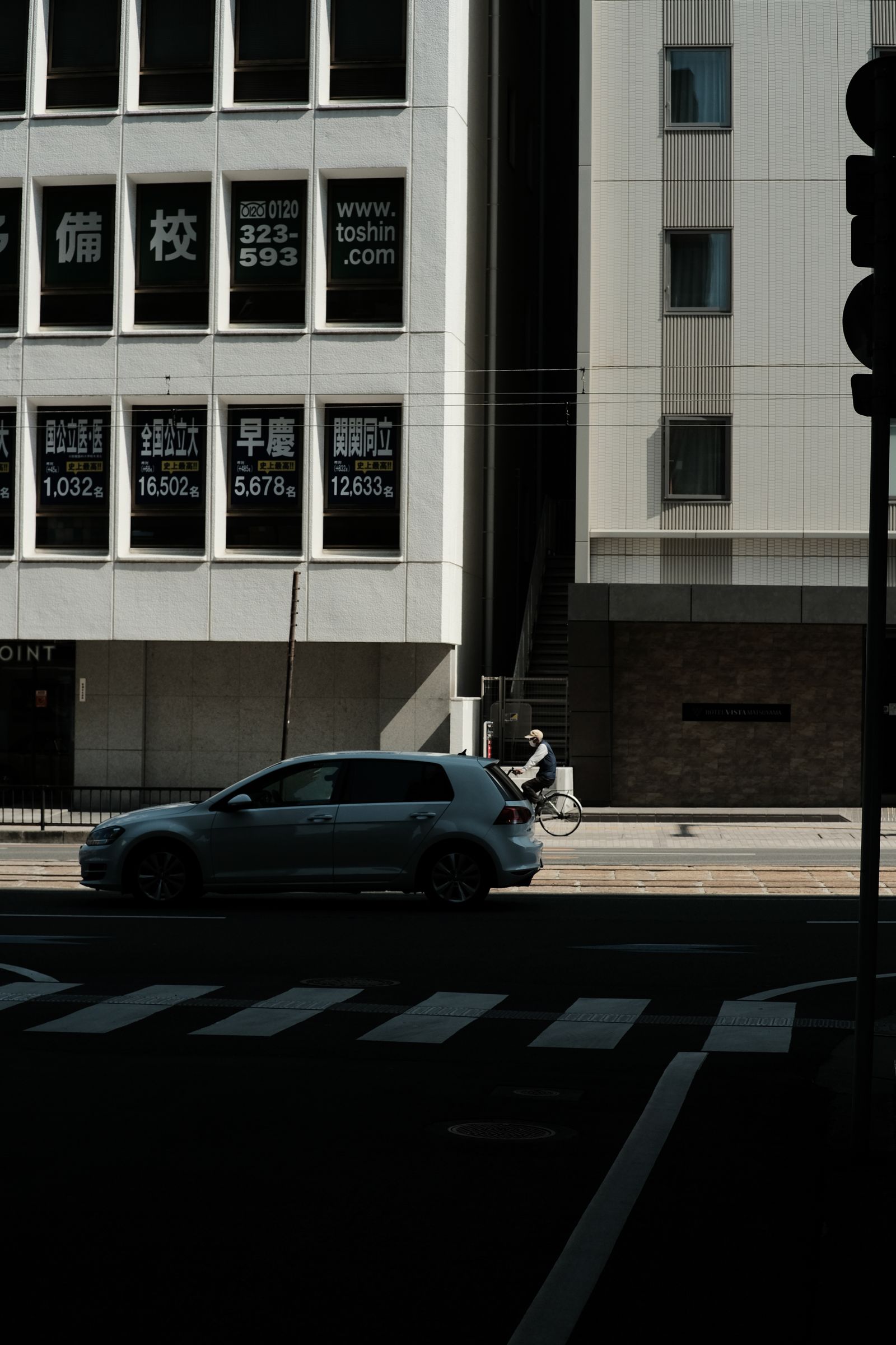 Cyclist and car traveling on an urban street