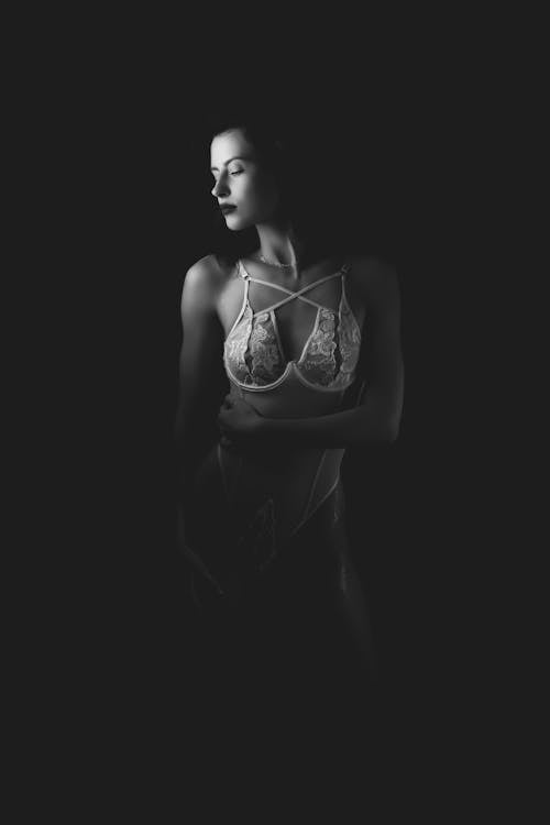 Black and White Photo of a Woman Posing in Lace Lingerie