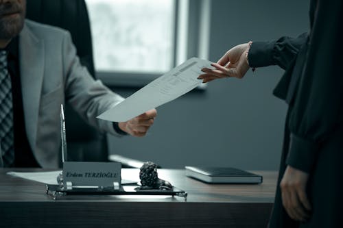 Woman Handing her Boss Document