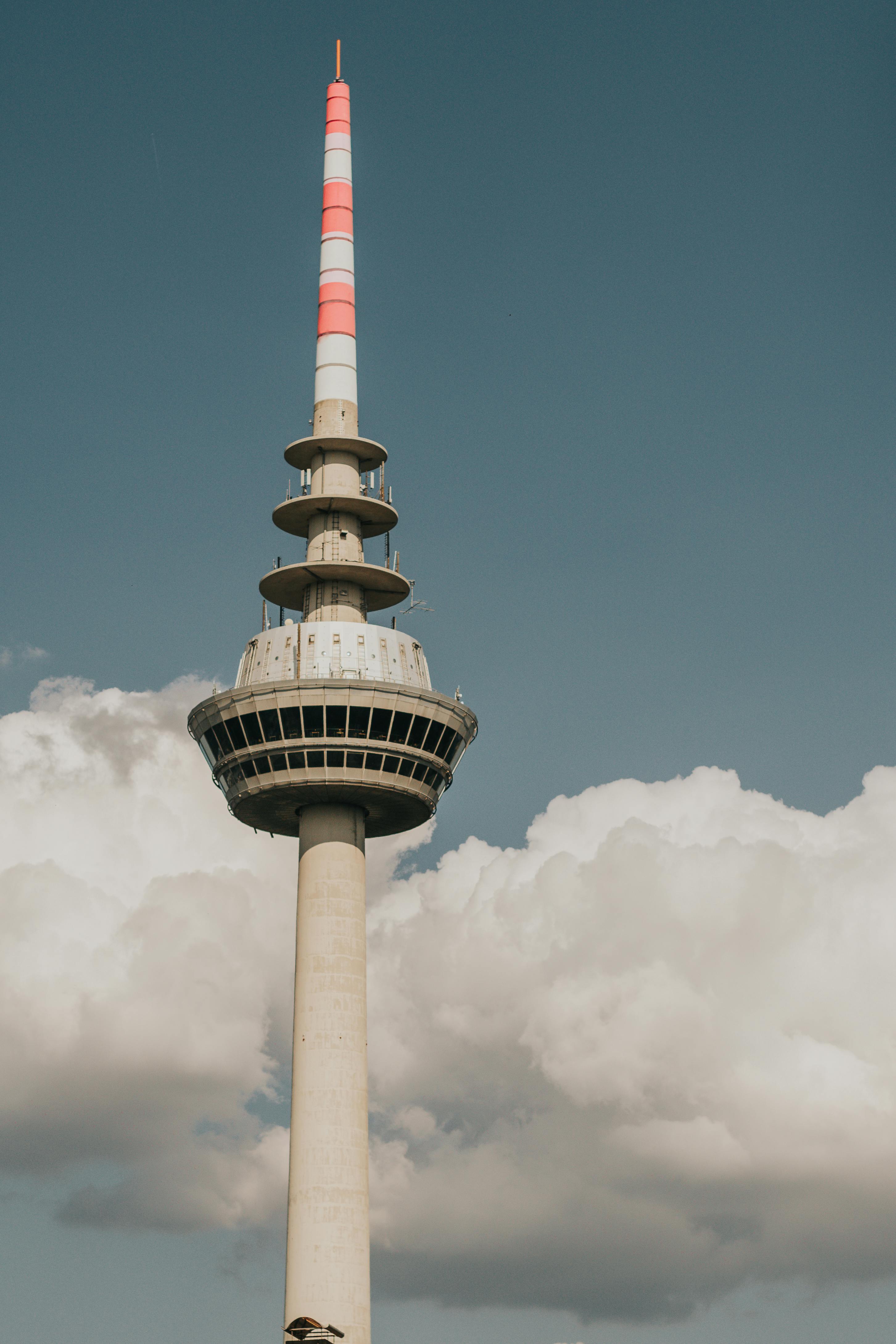 The iconic Mannheim Fernmeldeturm standing tall against a backdrop of clouds.
